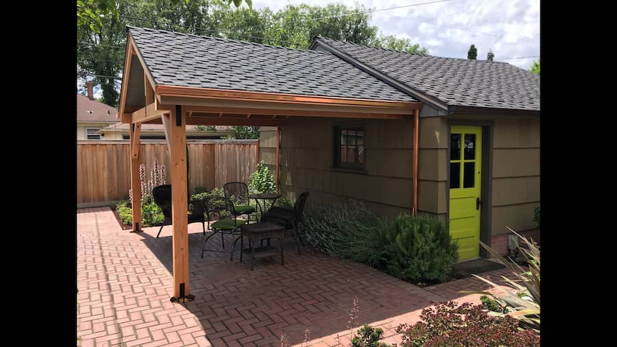 Copper K-style gutter with round downspout on a residential roofline