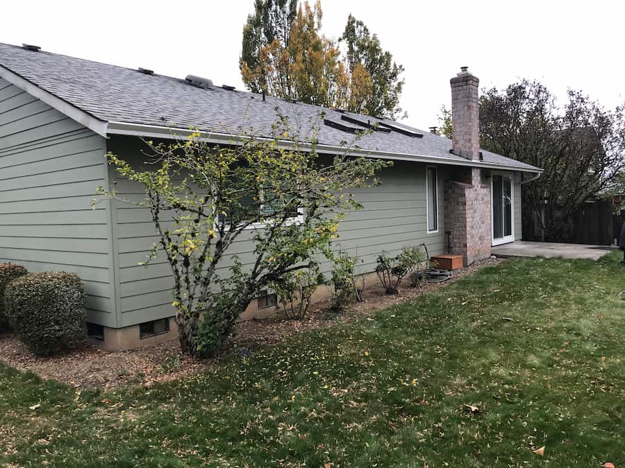 Gutter installed on the exposed rafter tails of a craftsman-style home