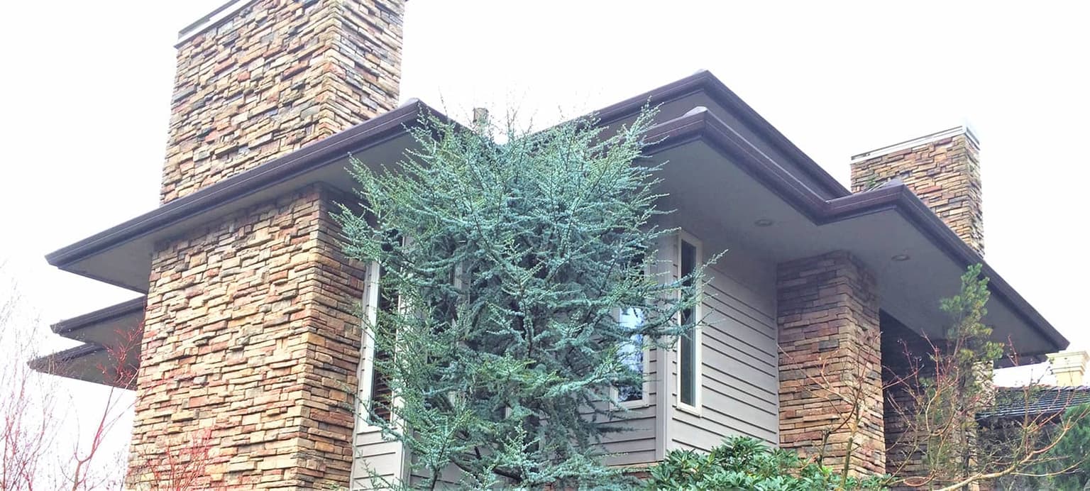 New seamless gutters installed along the full roofline of a home
