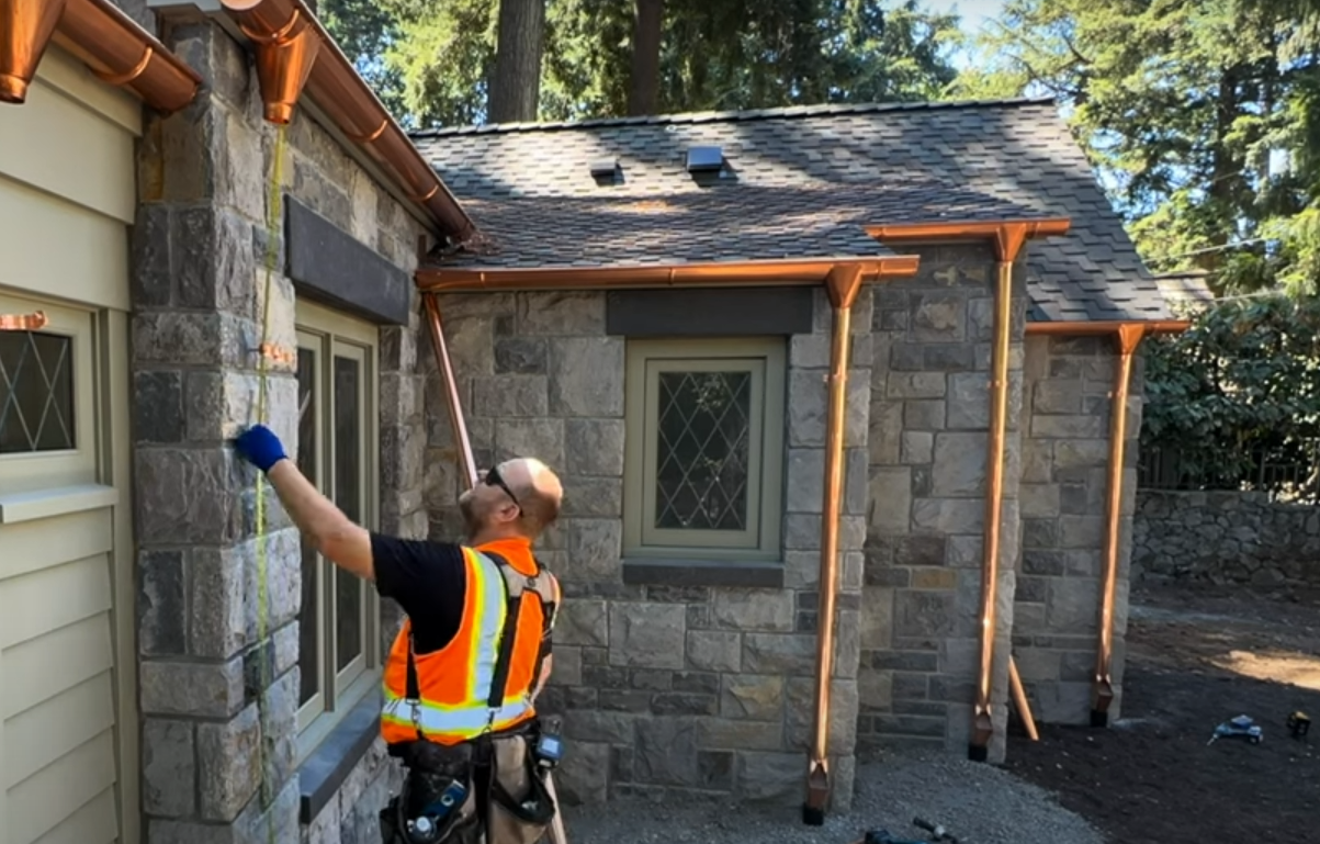 Royal Gutters professional gutter installation on stone home in Portland Oregon